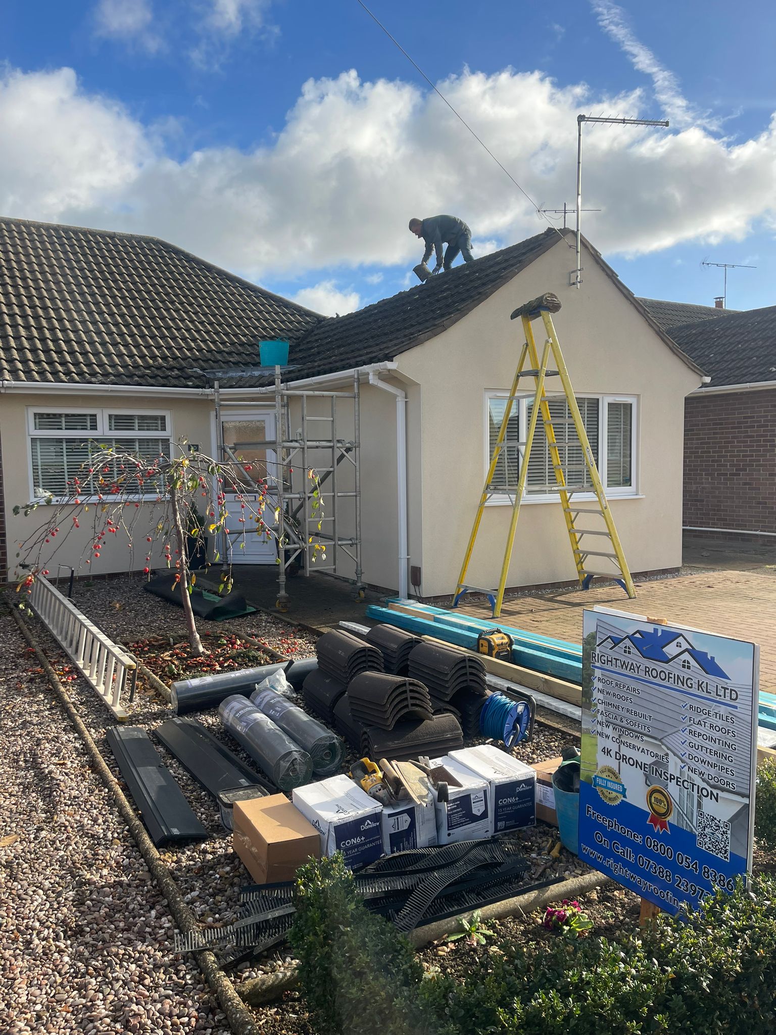 Rightway Roofing team with company sign